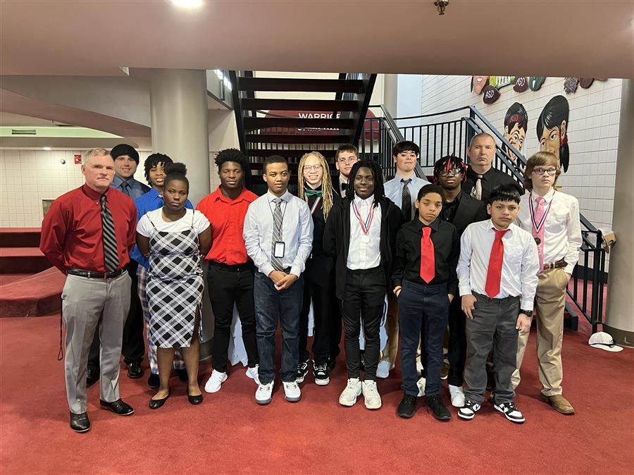  The Alabama School for the Blind Wrestling Team pose as a group and smile to the camera. 